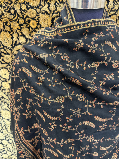 Black fabric with gold embroidery on a patterned background