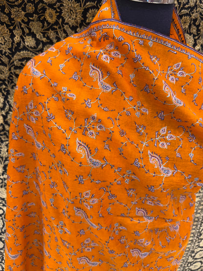 Orange fabric with paisley pattern on a textured background